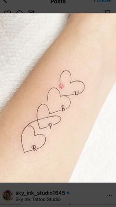 an arm with three hearts on it and the word love written in cursive writing