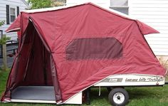 a red tent sitting on top of a trailer