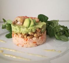 a white plate topped with an avocado and other food on top of it