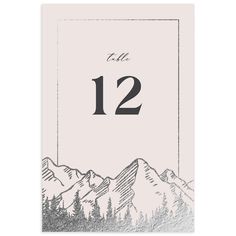 a table number card with mountains in the background