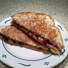 a grilled cheese and jelly sandwich on a plate