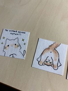 three small stickers with pictures of cats on them