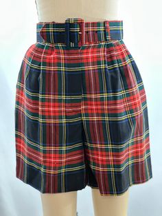 These vintage 90s shorts will be your new favorite. High waisted, they are belted, and have a classic plaid colored pattern .  Keep it super minimal with a fitted white tee or add a flowered short for a pattern on pattern look. -Vintage 90s -High Rise, plaid, pleated, belted -Machine wash recommended Measurements: *Waist 12 inches *Hips 16 1/2  inches *Inseam 6 1/4 inches *Length 18 3/4  inches *This item is pre-loved and there may be minor flaws to the garment. Not to worry if there is anything Fitted High Waist Shorts For School, Retro High Waist Shorts With Belt Loops, Retro Short Length School Bottoms, Retro Short School Bottoms, Retro Shorts With Belt Loops, Vintage Plaid Shorts Outfit, Preppy Plaid Short Bottoms, Vintage Shorts With Belt Loops, Retro High-waisted Shorts With Belt Loops