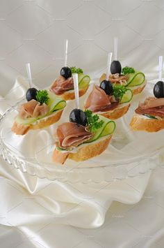 small appetizers with cucumber, olives and prosciutto