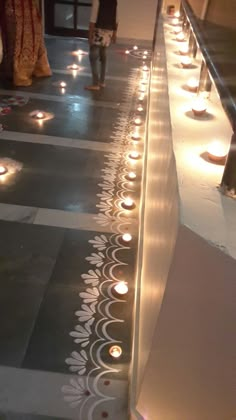 candles are lit in the middle of a walkway