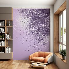 a living room with a chair and book shelf in front of a large purple wall