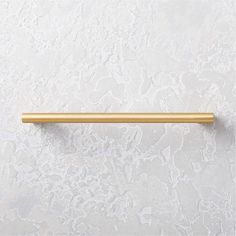 a gold handle on a white wall