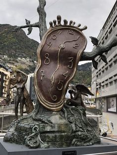 a bronze clock sitting on top of a statue