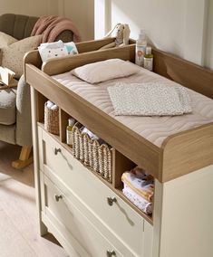 a baby's crib with lots of storage space in the bottom drawer,