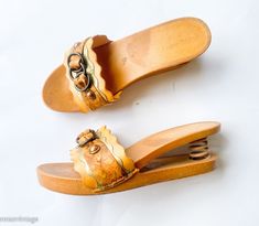 "~ 1970s fantastic wood sandals with spring heels ~ Gold & brown leather & plastic slides ~ Notice the spring heel ~ Rare wood shoes ~ Excellent Label:        Domo               Made in Italy Sole length- 9.5\"  (24.13 cm) Sole width- 3\"  (7.62 cm) Heel height- 2.5\"  (6.35 cm)               More Incredible Vintage:  glennasvintageshop.etsy.com Vintage Jewelry:  glennasjewels.etsy.com Instagram @glennas_clothing Facebook  https://www.facebook.com/glennasclothing" Spring Vintage High Heel Clogs, Vintage Summer Mules With Wooden Heel, Vintage Mules With Wooden Heel For Summer, Retro Mules With Wooden Heel For Spring, Vintage Brown Mules For Summer, Retro Brown Clogs For Spring, Vintage High Heel Wedge Sandals For Spring, Vintage Open Toe Mules With Wooden Heel, Spring Vintage High Heel Wedge Sandals