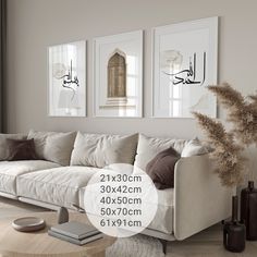 a living room with white couches and pictures on the wall above them in arabic calligraphy