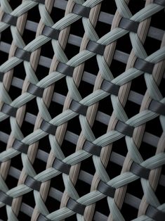 a close up view of a metal fence with wavy lines on the top and bottom