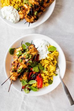 two white plates filled with different types of food