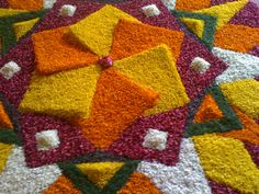 a close up view of a colorful rug with many squares and dots on it's surface