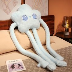 an octopus stuffed animal sitting on top of a bed