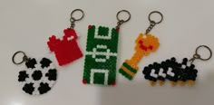 four different key chains made out of legos and plastic beads, each with an animal