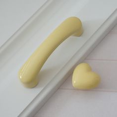 a yellow door handle with a heart shaped knob on the front and back of it