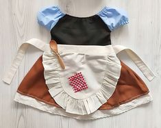 two aprons on top of each other, one with the letter k in it