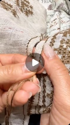 a woman is stitching fabric with scissors