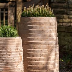 two cement planters sitting next to each other