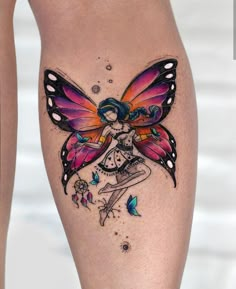 a woman's leg with a butterfly tattoo on her thigh and the image of a fairy