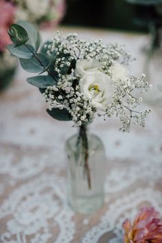 a vase filled with white flowers on top of a table