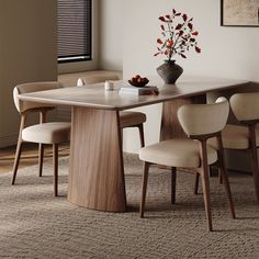 a dining room table with chairs and a vase filled with flowers on top of it