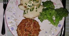 a plate with broccoli, cauliflower and meat on it next to a fork