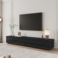 a flat screen tv mounted to the side of a wall in a white living room