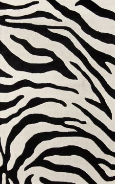 an animal print rug with black and white stripes