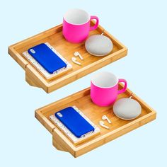 two wooden trays with cups and rocks on them, one is pink and the other is blue