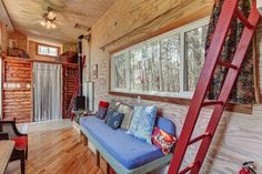 a living room filled with furniture and a ladder