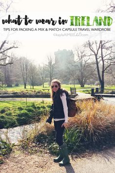 a woman standing in front of a river with trees and grass behind her, text overlay reads what to wear for ireland tips for packing a mix & match castle travel wardrobe