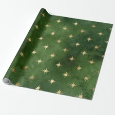 a green wrapping paper with gold stars on it