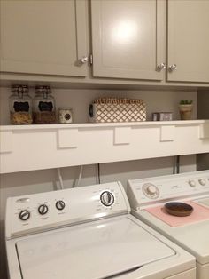 a white washer and dryer sitting next to each other in a laundry room