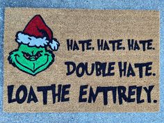 a door mat with an image of the grin face on it that says, water, hate, double hate, loath the entirely