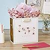 a white box with pink flowers in it sitting on a desk