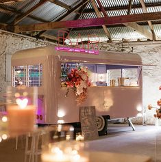 an ice cream truck is decorated with flowers and lit candles for a wedding or event