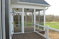 a screened porch with sliding glass doors on the side