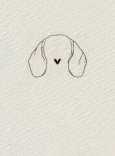 a drawing of a dog's head with a heart in the middle on a white wall