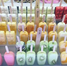 an assortment of different colored popsicles on sticks