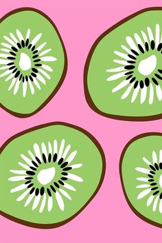 four slices of kiwi fruit on a pink background with black and white designs in the center