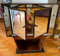 an open glass display case sitting on top of a hard wood floor