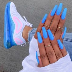 a woman's hand with bright blue nails