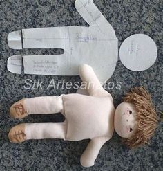 a doll is laying on the ground next to paper