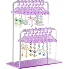 a purple shelf with lots of jewelry hanging from it's sides and stars on the bottom