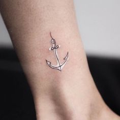 a small anchor tattoo on the ankle