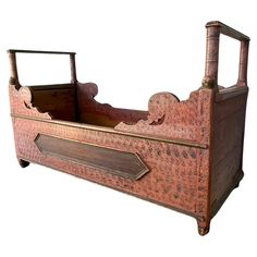 an old wooden bed with two drawers on it