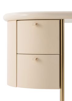 a white table with two drawers and a gold metal handle on the bottom half of it