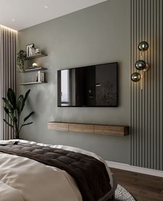 a bedroom with a large bed and a flat screen tv mounted on the wall